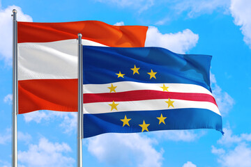 Cape Verde and Austria national flag waving in the windy deep blue sky. Diplomacy and international relations concept.