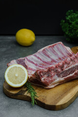 A lump of fresh rib cut is photographed on a cutting board.