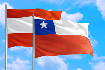 Chile and Austria national flag waving in the windy deep blue sky. Diplomacy and international relations concept.