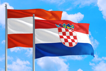 Croatia and Austria national flag waving in the windy deep blue sky. Diplomacy and international relations concept.