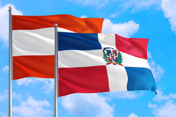 Dominican Republic and Austria national flag waving in the windy deep blue sky. Diplomacy and international relations concept.