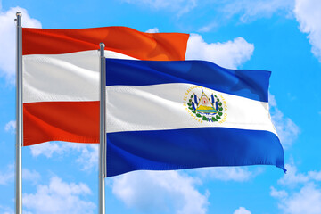 El Salvador and Austria national flag waving in the windy deep blue sky. Diplomacy and international relations concept.