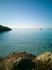 Cristal clear water and no people at the famous Cala Azzurra in Favignana, Italy. A perfect calm sunrise in this paradise island in the mediterranean sea