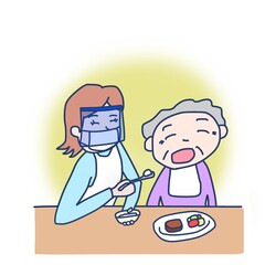 高齢者に食事の介助をしている女性（マスク、フェイスシールド、黄色背景あり）