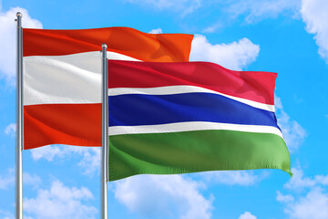 Gambia and Austria national flag waving in the windy deep blue sky. Diplomacy and international relations concept.