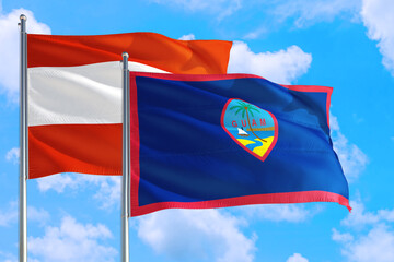 Guam and Austria national flag waving in the windy deep blue sky. Diplomacy and international relations concept.