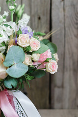 Half a bouquet of eucalyptus and roses and peonies for a background on wooden