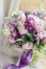 Lilac bouquet with pastel green roses and ribbon