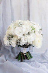 Wedding white bouquet on a gentle gray background. Bridesmaid, mom wedding details. Morning of the bride