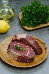 Red meat chunks in a wooden plate.