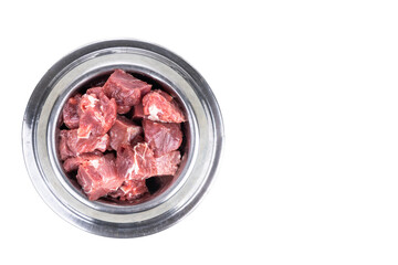 Overhead view on serving of raw barf beef meat chunk for dog meal