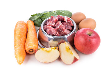 Ingredients of barf raw food recipe for dogs consisting meat, eggs and vegetable