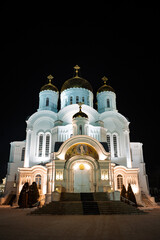 Fototapeta na wymiar Orthodox Church at night illuminated by lights, old white Church, night architecture