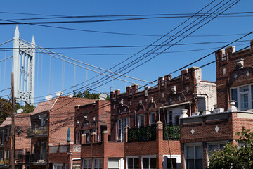 Fototapeta na wymiar Row of Old Brick Homes with the Triborough Bridge in Astoria Queens New York