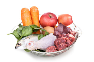 Ingredients of barf raw food recipe for dogs consisting meat, organs, fish, eggs and vegetable