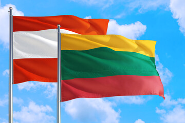 Lithuania and Austria national flag waving in the windy deep blue sky. Diplomacy and international relations concept.