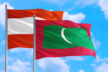 Maldives and Austria national flag waving in the windy deep blue sky. Diplomacy and international relations concept.