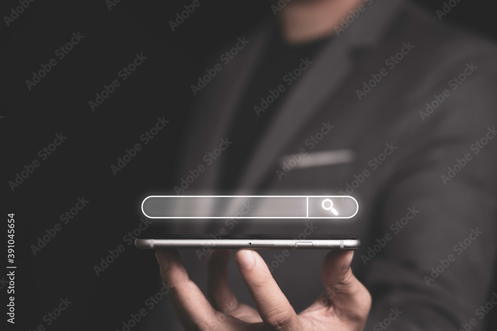 Poster search engine optimisation or seo concept , businessman holding smartphone for using input keyword a