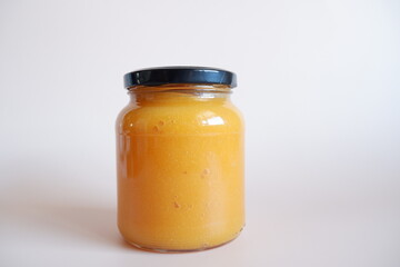 Glass jam pot with black lid and a white background mockup 