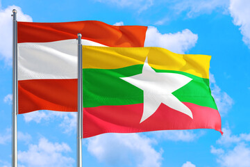 Myanmar and Austria national flag waving in the windy deep blue sky. Diplomacy and international relations concept.