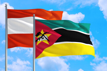 Mozambique and Austria national flag waving in the windy deep blue sky. Diplomacy and international relations concept.