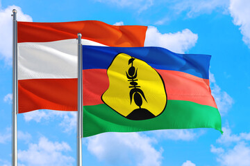 New Caledonia and Austria national flag waving in the windy deep blue sky. Diplomacy and international relations concept.