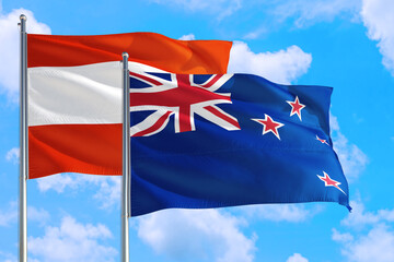 New Zealand and Austria national flag waving in the windy deep blue sky. Diplomacy and international relations concept.