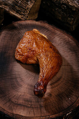 Smoked Chicken thigh fragrant juicy, on a wooden board. Top view.
