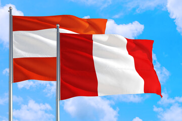 Peru and Austria national flag waving in the windy deep blue sky. Diplomacy and international relations concept.
