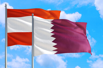 Qatar and Austria national flag waving in the windy deep blue sky. Diplomacy and international relations concept.