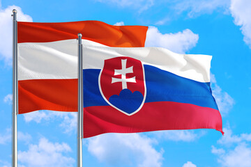 Slovakia and Austria national flag waving in the windy deep blue sky. Diplomacy and international relations concept.