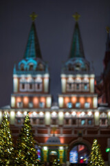 Russia, Moscow New Year. Defocused abstract image of the Kremlin towers and Christmas trees.