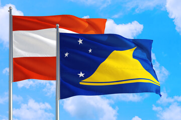 Tokelau and Austria national flag waving in the windy deep blue sky. Diplomacy and international relations concept.