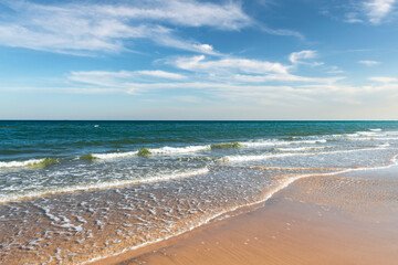 Tide waves on tropical beach sand and blue ocean water. Beauty sea texture. Vacations background