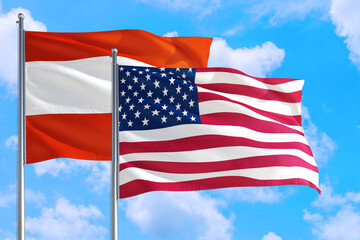 United States and Austria national flag waving in the windy deep blue sky. Diplomacy and international relations concept.