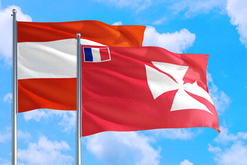 Wallis And Futuna and Austria national flag waving in the windy deep blue sky. Diplomacy and...