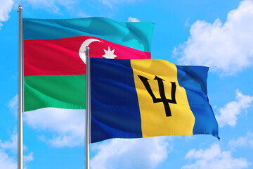 Barbados and Azerbaijan national flag waving in the windy deep blue sky. Diplomacy and international relations concept.