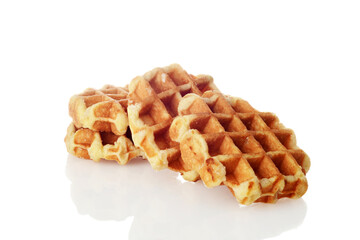 pile of homemade belgian waffles on white