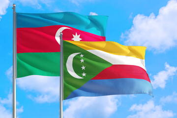 Comoros and Azerbaijan national flag waving in the windy deep blue sky. Diplomacy and international...