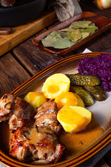 Rustic Snirtjebraten with red cabbage and cucumber