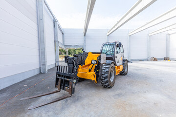 Industrial warehouse construction. Rotating telehandler vehicle