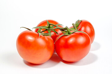 close-up of red juicy tomatoes on one branch