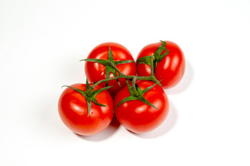 Close-up of red juicy tomatoes on one branch. View from above