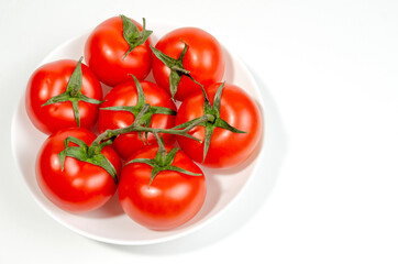 several red tomatoes on a branch isolated on white background