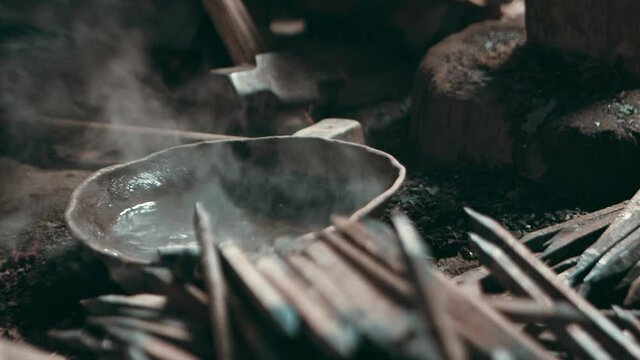 Hot metal piece placed in a water, releasing hot steam