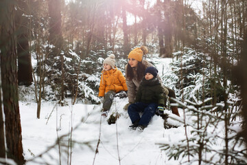 Happy family playing and laughing in winter outdoors in the snow. City park winter day.