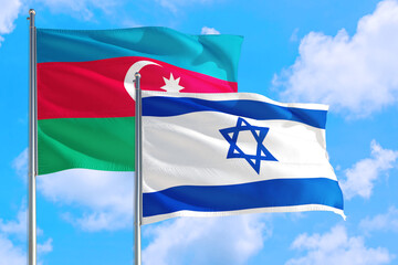 Israel and Azerbaijan national flag waving in the windy deep blue sky. Diplomacy and international relations concept.
