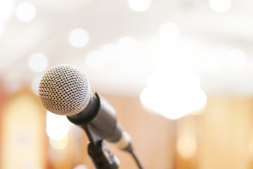 Microphone close up in meeting seminar room blurred background with bokeh