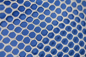 white net on blue plastic rubber surface © Ingo Menhard/Wirestock