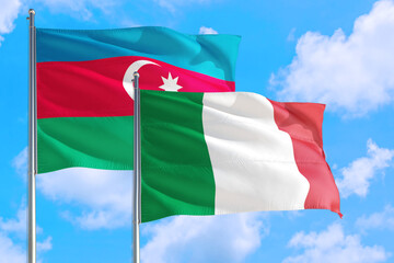 Italy and Azerbaijan national flag waving in the windy deep blue sky. Diplomacy and international relations concept.